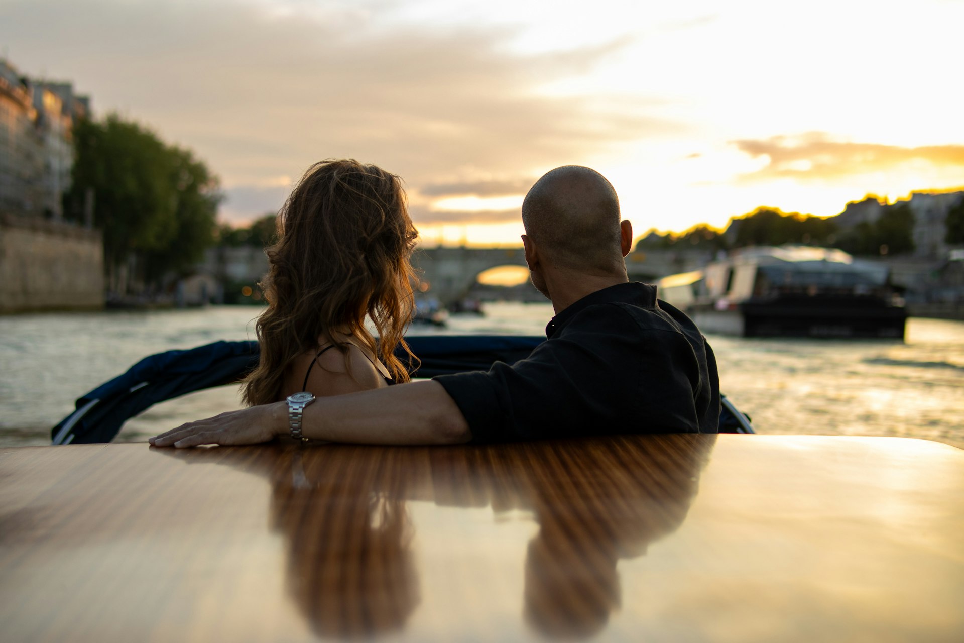 A man and a woman are sitting on a boat